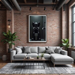 May include: A modern living room with a gray sectional sofa, a rectangular coffee table, and a gray patterned rug. A framed artwork of a black figure on a toilet hangs on the brick wall. Potted plants add greenery to the space.