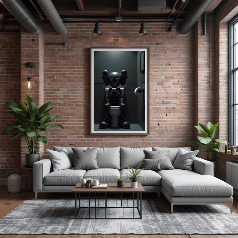 May include: A modern living room with a gray sectional sofa, a rectangular coffee table, and a gray patterned rug. A framed artwork of a black figure on a toilet hangs on the brick wall. Potted plants add greenery to the space.