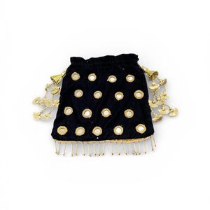 May include: Black velvet drawstring bag adorned with circular mirrors and gold-colored tassels. The bag features a gold trim along the bottom edge and at the top, with gold tassels hanging from the sides. The bag is a small size.