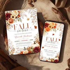 May include: A printed bridal shower invitation and a smartphone displaying the same digital invitation design, featuring watercolor illustrations of burgundy and orange roses, sunflowers, autumn leaves, and white pumpkins with the text Fall in love.