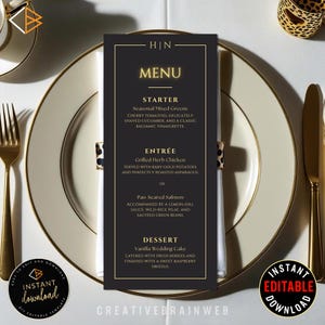 May include: A black menu card with gold trim, featuring the word "MENU" in gold lettering. The menu lists a starter, entree, and dessert. The menu is placed on a white plate with gold trim, alongside gold silverware.
