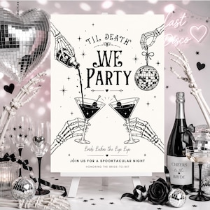 May include: A white rectangular sign on a stand featuring black line art of skeleton hands holding a bottle, a disco ball, and two martini glasses. The text reads: TIL DEATH WE PARTY, Bride Before the Bye Bye, JOIN US FOR A SPOOKTACULAR NIGHT.