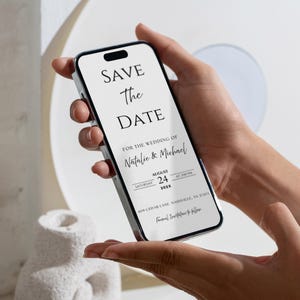 May include: A smartphone screen shows a wedding "Save the Date" announcement. The text includes the names "Natalie & Michael", the date August 24, 202X, and the time 2:00 PM. The announcement also includes the address 409 Cedar Lane, Nashville, TN 31201.