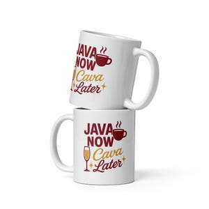 May include: Two white ceramic coffee mugs stacked on top of each other. Each mug has the words "JAVA NOW Cava Later" in burgundy and gold lettering, with a coffee cup and champagne glass graphic.
