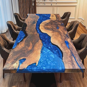 May include: A rectangular dining table featuring two large slabs of natural wood with a prominent grain pattern, separated by a central river-like inlay of vibrant blue swirling resin. The table is surrounded by six dark brown upholstered chairs.