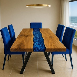 May include: A wooden dining table with a blue resin river design, surrounded by six blue upholstered chairs. The table has a dark metal base and is illuminated by a circular gold light fixture. The chairs are arranged around the table, creating a modern dining set.
