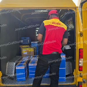 May include: A yellow DHL delivery van with the back door open, revealing packages and a delivery person. The person is wearing a red and yellow DHL uniform and a red cap. Blue boxes labeled "FRAGILE" are visible.