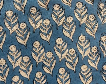 May include: A thick cotton fabric featuring a repeating pattern of off-white floral motifs with dark outlines set against a solid blue background. The text at the bottom of the image reads: FABRIC - THICK COTTON WHITE 63" WIDTH.