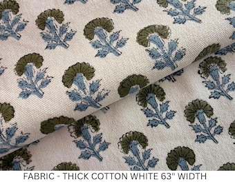 May include: A thick white cotton fabric featuring a repeating floral pattern of olive green and light blue stylized flowers. The fabric has a visible woven texture and is labeled as having a 63 inch width in the text below the image.