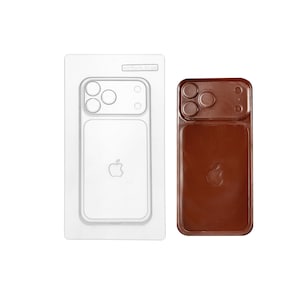 May include: A clear plastic mold and a brown chocolate phone case. The mold has a phone-shaped cavity with camera and logo details. The chocolate case mirrors the mold's design, featuring camera cutouts and an Apple logo.