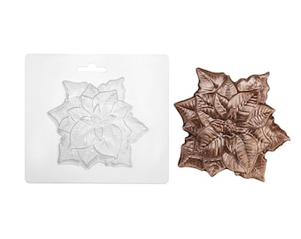 May include: A clear plastic poinsettia-shaped mold with a hanging hole at the top and a finished bronze-colored poinsettia casting featuring detailed veined petals and a textured center, displayed side-by-side on a plain white background.