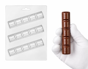 May include: A clear plastic rectangular mold featuring three identical cavities shaped like long, segmented chocolate bars, alongside a single finished brown chocolate bar with four distinct rounded sections and horizontal ridges.