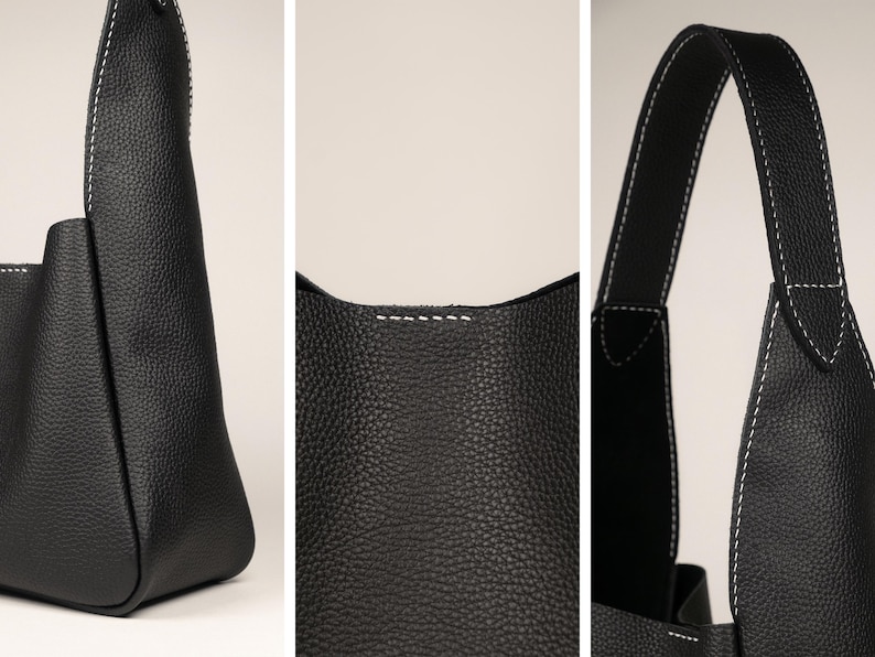 May include: Close-up shots of a black leather tote bag with white stitching. The bag has a textured surface and a simple, modern design. The stitching is visible along the seams and handles, adding a contrasting detail.