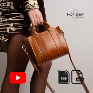 Könnte beinhalten: Eine kleine, rechteckige, hellbraune Lederhandtasche mit einem oberen Griff und einem abnehmbaren Schulterriemen. Die Tasche hat sichtbare Nähte und silberfarbene Beschläge. Der Markenname "FONDER Atelier" ist oben rechts sichtbar.