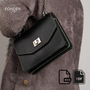 Könnte beinhalten: Schwarze Leder-Umhängetasche mit silbernem Verschluss und Kettenriemen. Die Tasche hat weiße Nähte und ein grünes Innenfutter. Der Text "FONDER Atelier" ist sichtbar. SVG- und PDF-Symbole unten rechts.