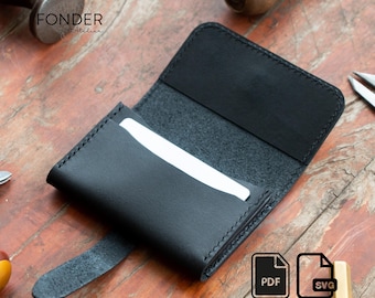 May include: Black leather card holder with a flap closure. The card holder is open, revealing a white card inside. The word "FONDER Atelier" is printed on the top left. PDF and SVG icons are in the bottom right.
