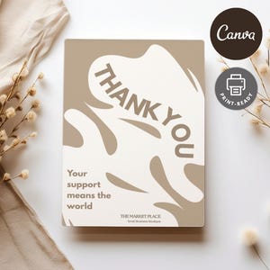 Könnte beinhalten: Beige-weiße "Thank You"-Karte mit abstrakten Formen und dem Text "Your support means the world". Die Karte enthält auch den Text "THE MARKET PLACE Small Business Boutique."
