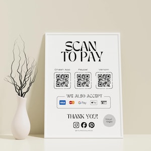 Könnte beinhalten: Ein weiß gerahmtes Schild mit dem Text "SCAN TO PAY" und QR-Codes für Cash App, PayPal und Venmo. Es zeigt auch akzeptierte Zahlungsmethoden an: Visa, Mastercard, Google Pay und Apple Pay. Das Schild sagt "THANK YOU!" und enthält Social-Media-Symbole.