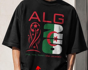 May include: A black short-sleeved t-shirt featuring a graphic with the text ALG, a soccer ball, and the Algerian flag. Below the graphic, the text reads ONE, TWO, THREE VIVA L'ALGÉRIE! A small oval graphic at the bottom left contains the text CUSTOM TEXT.