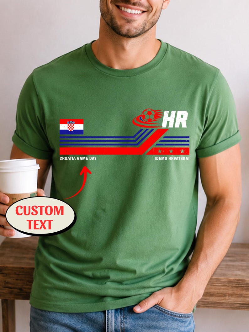 May include: An olive green t-shirt featuring a graphic with the Croatian flag, a soccer ball, and the text HR, CROATIA GAME DAY, and IDEMO HRVATSKA. A red arrow points to the text CROATIA GAME DAY with a bubble labeled CUSTOM TEXT.
