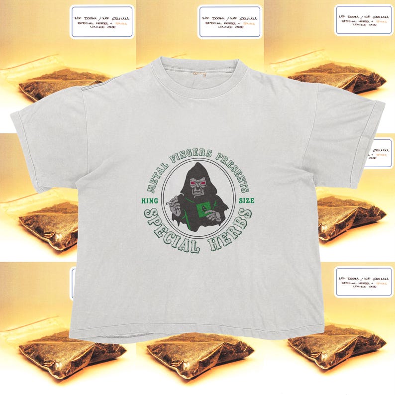 May include: White t-shirt with a graphic of a hooded figure with red eyes, the text "METAL FINGERS PRESENTS" and "KING SIZE SPECIAL HERBS" in a circular design. Small packages with text surround the shirt.