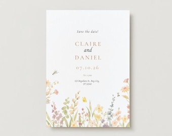May include: A rectangular wedding invitation with a watercolor floral design. The text "Save the date!" is at the top, followed by "CLAIRE and DANIEL" and the date "07.10.26". The bottom features an address. The design includes yellow, pink, and purple flowers.