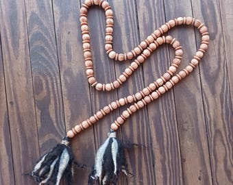 Natural wooden beaded swag garland with wool tassels