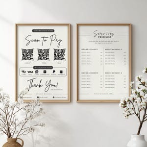 May include: Two framed signs with a light background. One sign says "Scan to Pay" with QR codes and payment options. The other sign is a service pricelist. Floral arrangements in vases are in the foreground.