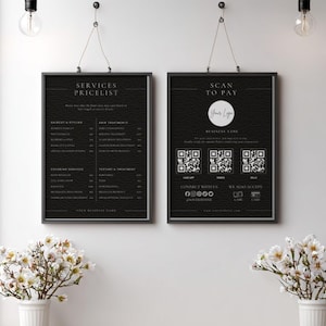 May include: Two framed black signs hang on a white wall. The left sign reads "SERVICES PRICELIST" and lists services and prices. The right sign says "SCAN TO PAY" with a logo, QR codes, and payment options. Floral arrangements are in the foreground.