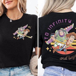 May include: Black t-shirt featuring a cartoon graphic of Buzz Lightyear and Woody from Toy Story. The front has a small image of the characters, while the back displays a larger design with the text "TO INFINITY and beyond."
