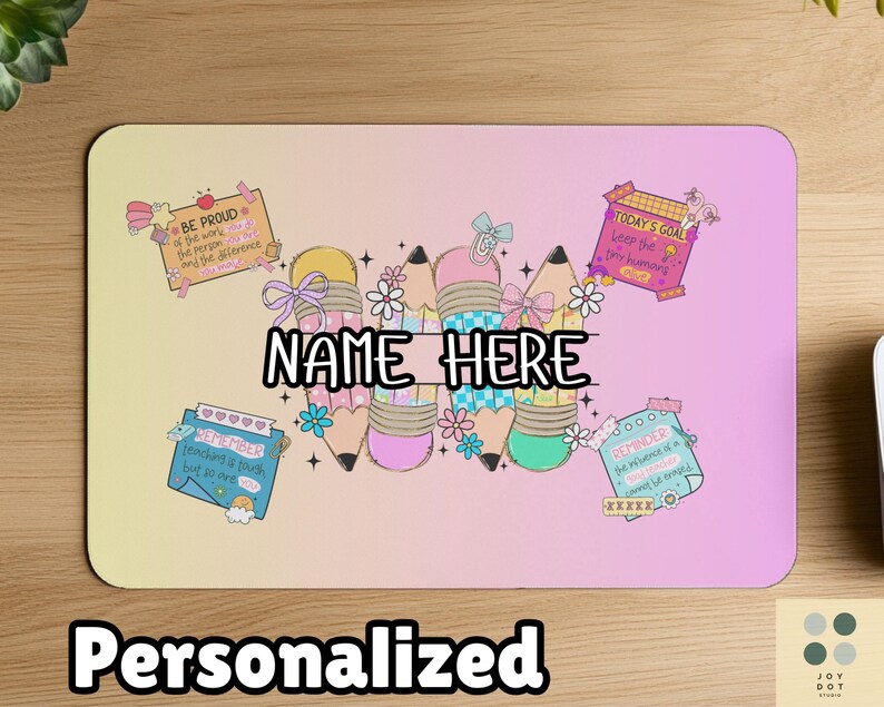 May include: Personalized mousepad with a pastel gradient background. The design features pencils with bows and flowers, and text that says "NAME HERE". Additional text includes "BE PROUD", "TODAY'S GOAL", and "REMEMBER".