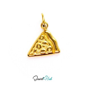 May include: A gold-toned metal charm shaped like a triangular slice of pizza, featuring embossed circular details representing toppings and a raised crust edge. The charm includes a small circular jump ring at the top for attachment. Text reads Jewel Hub.