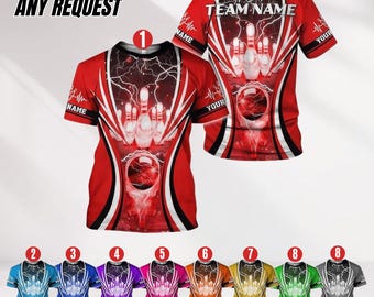 May include: Red bowling shirt with a bowling pin and ball design. The shirt has a lightning bolt graphic and the text "TEAM NAME". Additional shirts in blue, purple, pink, orange, yellow, green, and gray are also shown.