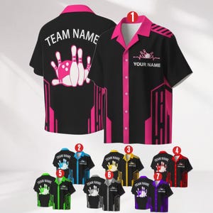 May include: Black bowling shirt with pink accents, featuring a bowling pin and ball graphic. The shirt has a button-up front, short sleeves, and the text "YOUR NAME" and "TEAM NAME". Additional shirts in various colors are also shown.