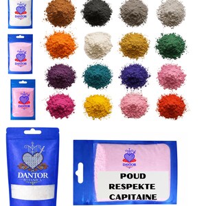 May include: A collection of colorful powder pigments and packaged products. The image features various shades of powder, including brown, black, gray, orange, white, yellow, green, purple, teal, blue, pink, and red. Several packages display the "DANTOR" logo.