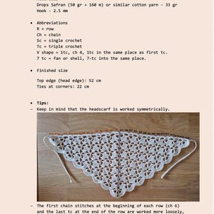 May include: A crocheted white headscarf with a detailed openwork pattern, displayed on a wooden surface. The top edge measures 20.5 inches, and the ties at the corners are 8.7 inches. The image also includes instructions and abbreviations for the crochet project.