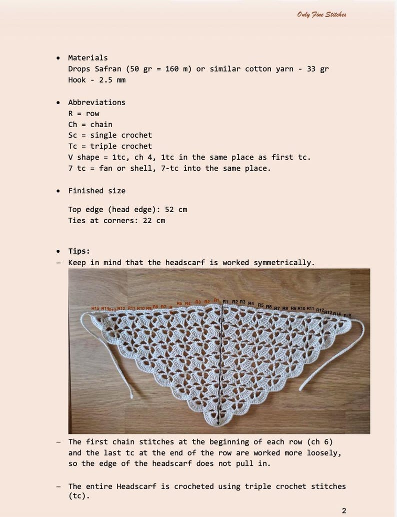 May include: A crocheted white headscarf with a detailed openwork pattern, displayed on a wooden surface. The top edge measures 20.5 inches, and the ties at the corners are 8.7 inches. The image also includes instructions and abbreviations for the crochet project.