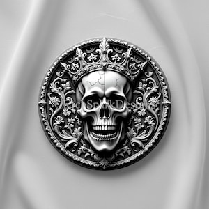 May include: A monochrome image of a skull wearing a crown, enclosed in a circular frame. The skull has a cracked forehead and a wide grin. The frame is decorated with floral and ornate scrollwork. The design is suitable for gothic or alternative decor.