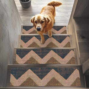 May include: A golden retriever dog descends a wooden staircase with patterned stair treads. The treads have a chevron design in navy, brown, and white. The stairs are in a domestic setting.