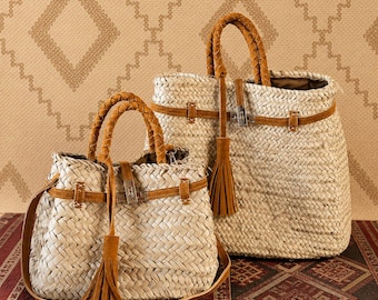 May include: Two woven straw handbags with brown leather detailing. The bags feature braided handles, leather straps, and decorative tassels. One bag has a shoulder strap. They are set against a patterned backdrop.