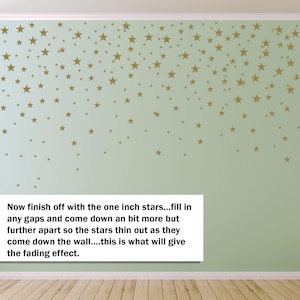 May include: A light green wall decorated with gold star decals of varying sizes. The stars are arranged to create a fading effect, with more stars at the top and fewer towards the bottom. Text on the image reads: "Now finish off with the one inch stars..."