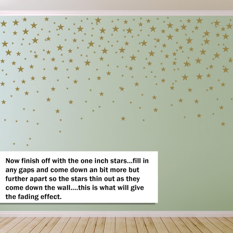May include: A light green wall decorated with gold star decals of varying sizes. The stars are arranged to create a fading effect, with more stars at the top and fewer towards the bottom. Text on the image reads: "Now finish off with the one inch stars..."