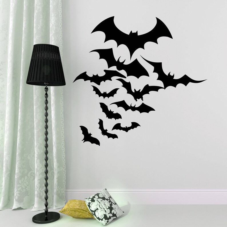 May include: A wall decal featuring a flock of black bats in various sizes and positions. The bats are arranged in a cascading pattern, creating a whimsical and spooky Halloween-themed design.