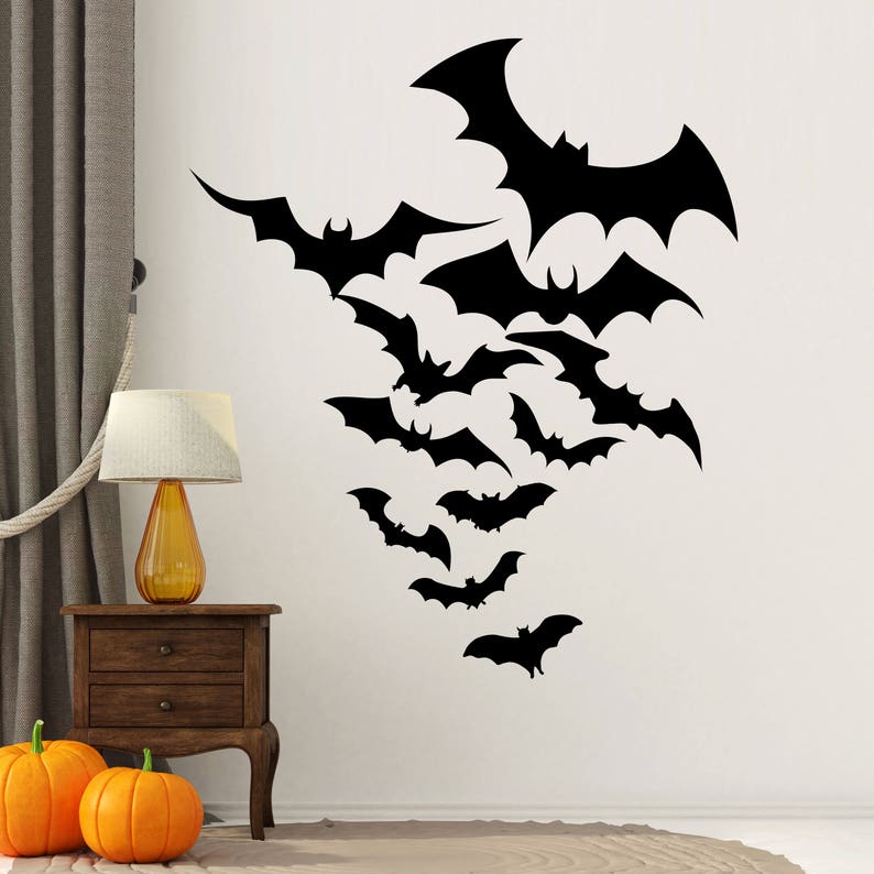 May include: A black and white wall decal featuring a group of bats in various sizes and positions. The bats are arranged in a cascading pattern, with the largest bat at the top and the smallest bats at the bottom.