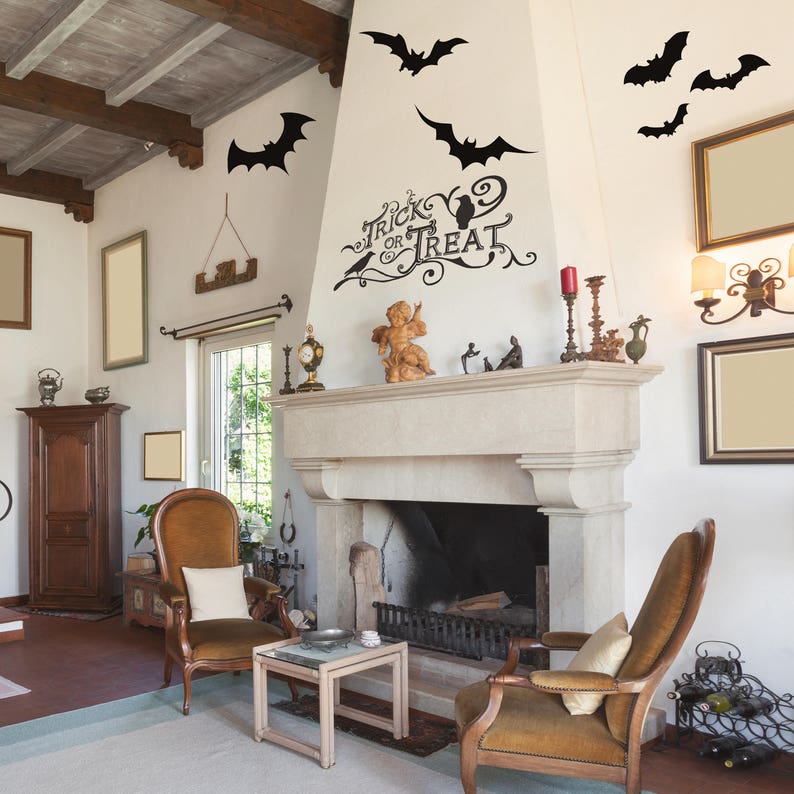 May include: A living room with a fireplace decorated with Halloween decorations. The decorations include bats and the words "Trick or Treat".