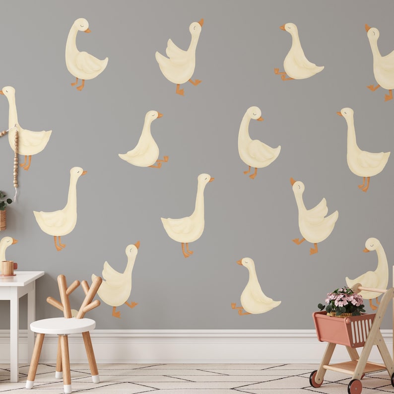 May include: A gray wall with a repeating pattern of white geese. The geese are in various poses, some are walking, some are standing, and some are looking up.