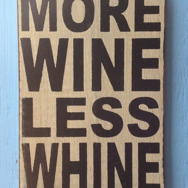 More wine less whine sign made from reclaimed plywood