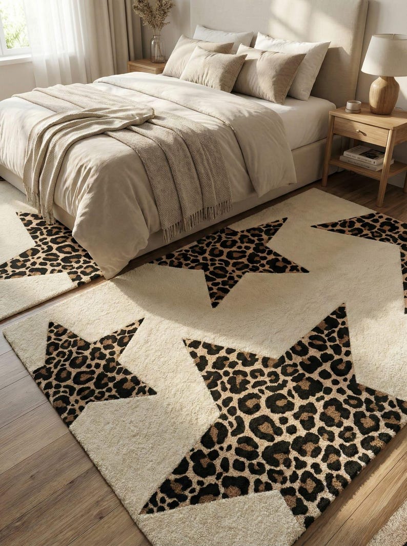 May include: Cream-colored star-shaped rugs with a leopard print design. The rugs are placed on a wooden floor in front of a bed with neutral-toned bedding. The room has a cozy, inviting atmosphere.