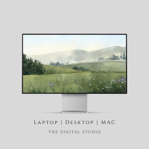 May include: A computer monitor shows a watercolour landscape of green hills, wildflowers, and a misty sky. The monitor is silver with a black border. Text at the bottom reads "LAPTOP | DESKTOP | MAC" and "THE DIGITAL STUDIO."