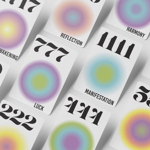 May include: A set of cards with colorful gradient circles and numbers. The cards feature different angel numbers and their meanings, such as 777 for luck, 1111 for manifestation, and 222 for spiritual awakening.